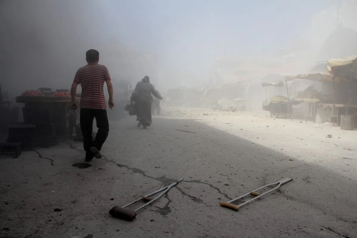 Syrians run away from the scene of a reported airstrike on the rebel-held northwestern city of Idlib on Sept. 10, 2016. More than 290,000 people have been killed in Syria since its conflict erupted in March 2011, and millions displaced by the fighting. (Omar Haj Kadour/AFP/Getty Images)