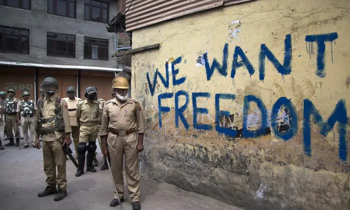Indian policemen stand guard during a curfew in Srinagar, Indian-controlled Kashmir, on Aug. 12, 2016. (AP Photo/Dar Yasin)