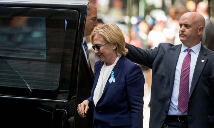 Democratic presidential candidate Hillary Clinton gets into a van as she leaves an apartment building Sunday, Sept. 11, 2016, in New York. Clinton's campaign said the Democratic presidential nominee left the 9/11 anniversary ceremony in New York early after feeling "overheated." (AP Photo/Andrew Harnik)