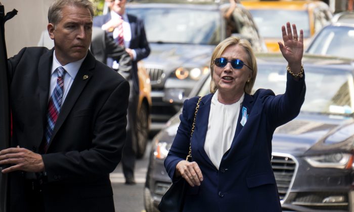 Democratic presidential candidate Hillary Clinton walks from her daughter's apartment building Sunday, Sept. 11, 2016, in New York. Clinton unexpectedly left Sunday's 9/11 anniversary ceremony in New York after feeling "overheated," according to her campaign. (AP Photo/Craig Ruttle)