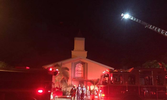 In this photo provided by the St. Lucie Sheriff's Office, firefighters work at the scene of a fire at the Islamic Center of Fort Pierce on Monday, Sept. 12, 2016, in Fort Pierce, Fla. (St. Lucie Sheriff's Office via AP)