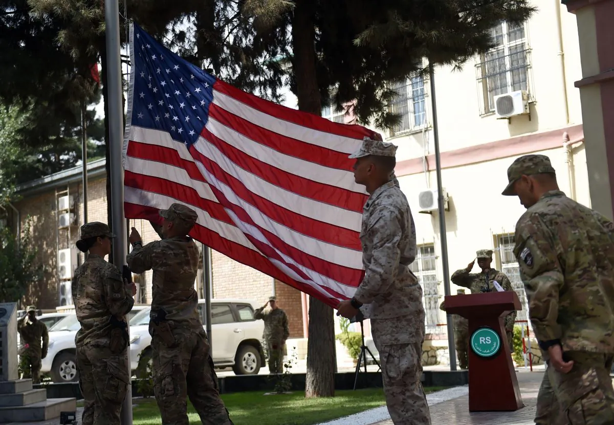 US military personnel lower the US flag at a memorial ceremony in honour of the 15th anniversary of the September 11, 2001 attacks on New York and Washington DC, at the International Security Assistance Force (ISAF) headquarters in Kabul on September 11, 2016.      (WAKIL KOHSAR/AFP/Getty Images)