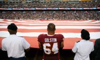Redskins Players Join Armed Forces Members in Holding Flag During National Anthem