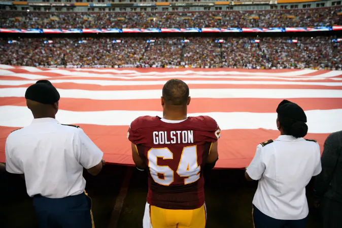 Defensive end Kedric Golston #64 of the Washington Redskins holds the American flag during the national anthem prior to a game against the Pittsburgh Steelers at FedExField on September 12, 2016 in Landover, Maryland. (Patrick Smith/Getty Images)