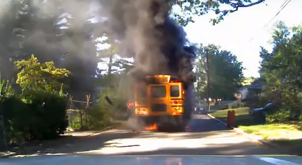 A screenshot from a dashboard camera video uploaded to YouTube shows the burning school bus in Prince George County, Maryland.  (Screenshot/YouTube)