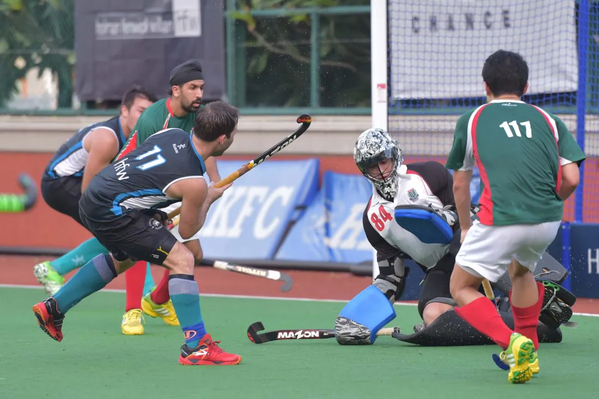 HKFC_A (blue) on the attack in their 12-0 win against KCC-A in the opening game of the Hong Kong Hockey Association, 2016 Premier Division campaign on Sunday Sept 11, 2016 to take them to top of the table. (Bill Cox/Epoch Times)