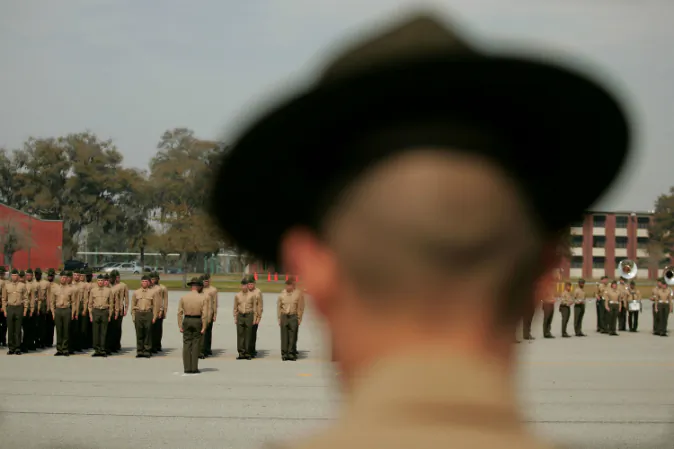 A United States Marine Corps drill instructor watches recruits on the parade deck during boot camp March 8, 2007 at Parris Island, South Carolina. The Department of Defense has asked Congress to increase the size of the Marine Corps by 27,000 troops and the Army by 65,000 over the next five years. An investigation has revealed that recruits were tormented with abuse by drill instructors. (Scott Olson/Getty Images)