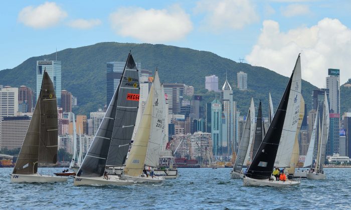 Sportsboats and J80’s set off on the 1st race of day 2 (Sunday Sept 11) of the RHKYC 2016 Autumn Regatta in Victoria Harbour,  Regatta winner in the Class R2B2 is leading the way followed by  the regatta No 2 boat Merlin. (Bill Cox/Epoch Times)