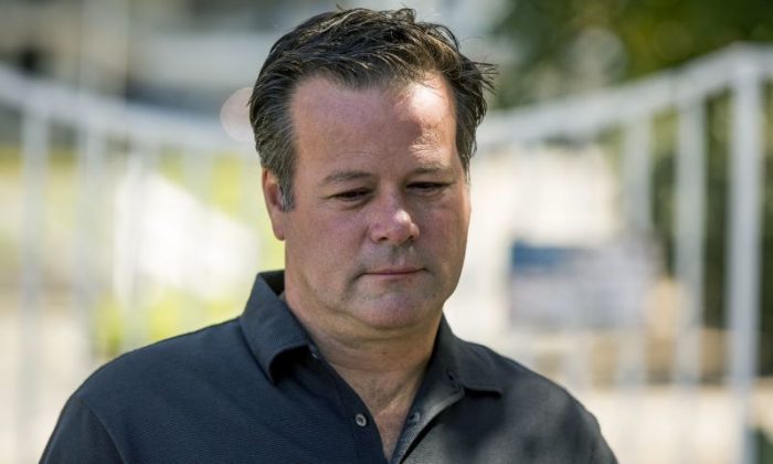 Former NASCAR racer Robby Gordon pauses while making a statement to members of the media gathered outside his home in Orange, Calif., on Thursday, Sept. 15, 2016. Gordon said his family is in shock and grieving the loss of his father and stepmother, who were found dead inside their Southern California home.  (AP Photo/Damian Dovarganes)