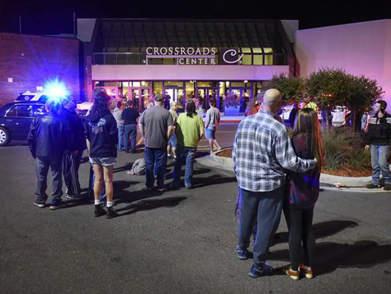 People stand near the entrance on the north side of Crossroads Center mall between Macy's and Target as officials investigate a reported multiple stabbing incident in St. Cloud, Minn., on Sept. 17, 2016. (Dave Schwarz/St. Cloud Times via AP)