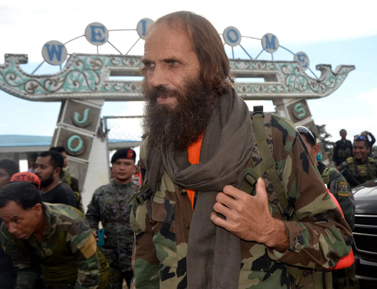 Released Norwegian hostage Kjartan Sekkingstad carries a backpack as he boards a plane to take him to Davao city for an audience with Philippine President Rodrigo Duterte on Jolo island, Sulu Province, in southern Philippines, on Sept. 18, 2016. (AP Photo/Nickee Butlangan)