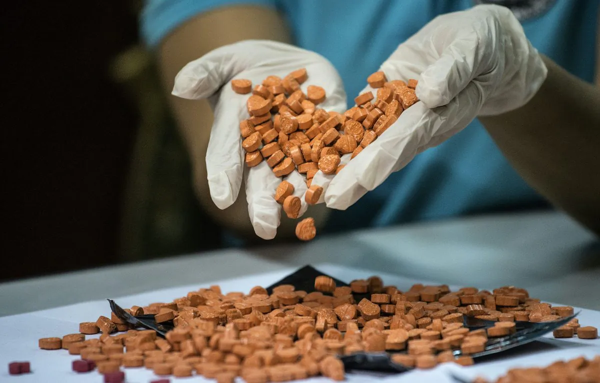 A Bureau of Customs (BOC) personnel displays confiscated illegal drugs, known Methylenedioxymethamphetamine (MDMA), commonly refered to as ecstasy, at a press conference at the BOC headquarters in Manila, Philippines, on Sept. 14, 2016. (Noel Celis/AFP/Getty Images)