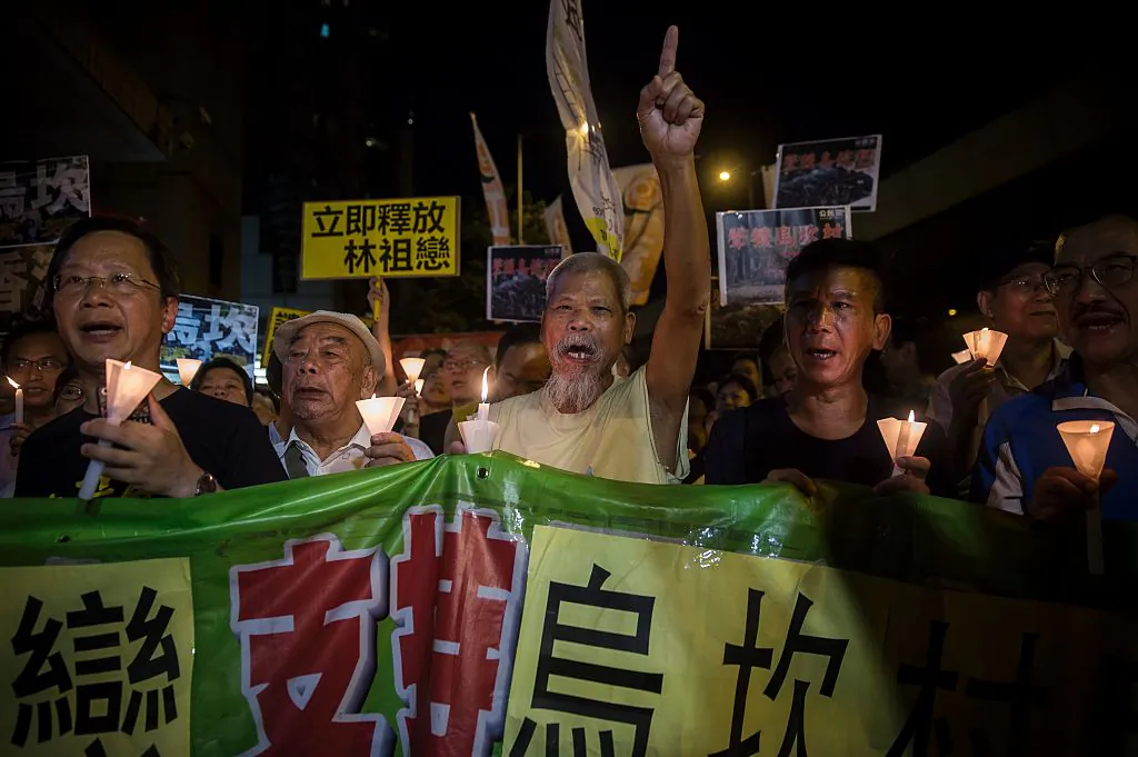 Protesters attend a candlelight vigil in support of China’s Wukan village outside the Chinese Liason Office in Hong Kong on Sept. 17, 2017. (Isaac Lawrence/AFP/Getty Images)