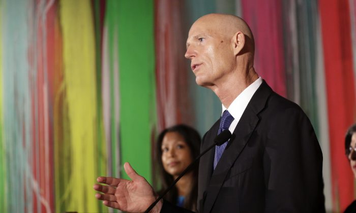 Florida Gov. Rick Scott speaks during a news conference at Wynwood Walls, Monday, Sept. 19, 2016, in the Wynwood neighborhood of Miami. The governor said the arts district is no longer considered a zone of active Zika transmission. It has been 45 days since the last Zika detection. (AP Photo/Lynne Sladky)