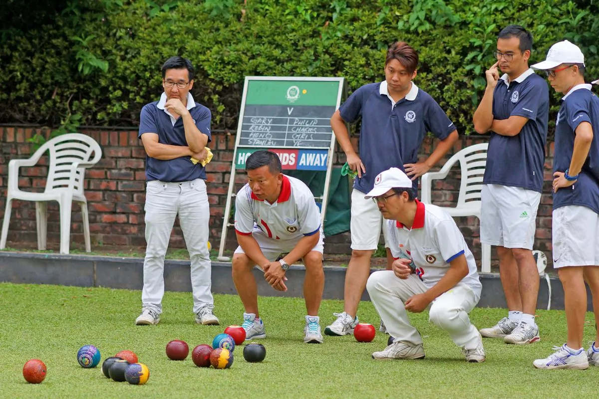 A tense moment for (L to R) back row Gary Pun, Lui Chi Hong, Robin Chok and Skip Stanley Lai of CCC-A as KBGC-A Philip Chan and Chris Chiu watch their Skip, Ye Sui Ying's last wood draw close to the jack to take 5 shots on the 17th end. However, Lai's team took 2 shots on the last end to win 20/15 with an overall score of 8/0 to CCC-A, and top position on the league table. KBGC-A lie second with 2 games in hand. (Mike Worth)