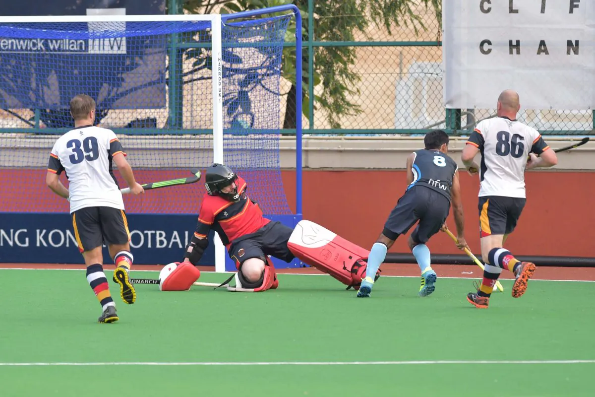 HKFC-A player (No 8) pushes the ball behind the HKCC-A goalie for his team mate to slide the ball into the goal for HKFC’s 1st of 2 goals in this exciting premier Hockey match at HKFC on Sunday Sept 18, 2016. HKFC-A won the match 2-0. (Bill Cox/Epoch Times)