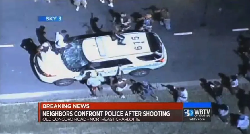 In this frame from video provided by WBTV, a police vehicle is damaged after protests broke out Tuesday, Sept. 20, 2016, in Charlotte, N.C., following a fatal shooting of a black man by police. (WBTV via AP)
