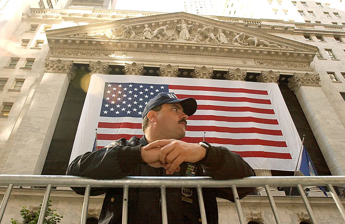 A New York Police Officer stands guard in front of the New York Stock Exchange on October 11, 2001 in New York, NY on the one month anniversary of the al-Qaeda attacks on the World Trade Center in New York and the Pentagon in Washington D.C. (Photo By Justin Sullivan/Getty Images)v