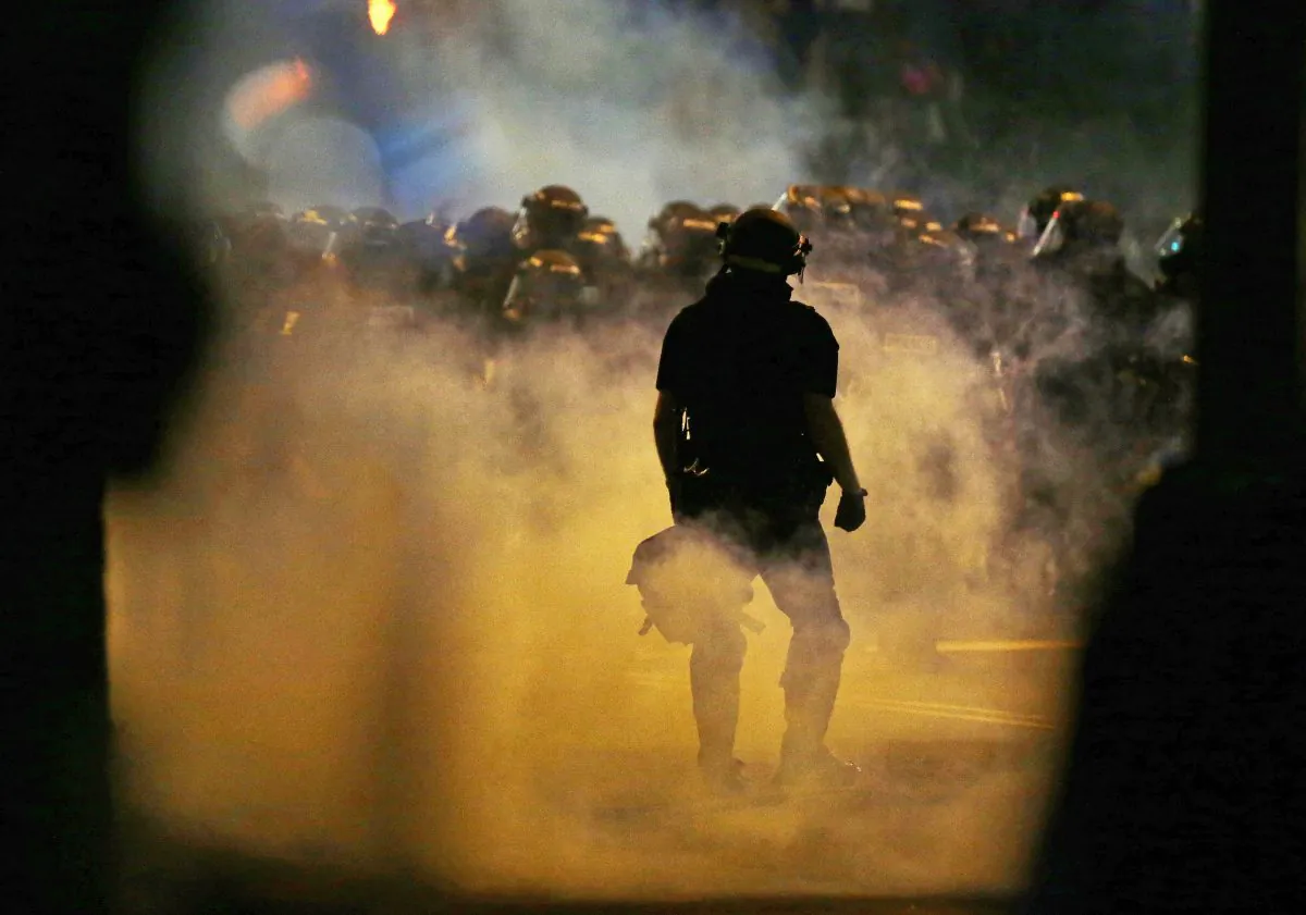 Police fire teargas as protestors converge following the police shooting of Keith Lamont Scott in Charlotte, N.C., on Sept. 21, 2016. (Gerry Broome/AP Photo)