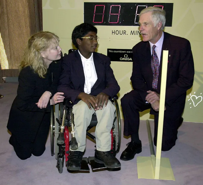 US Actress Mia Farrow (L) and her adopted son Thaddeus, whos suffers from polio (C), talk with media mogul Ted Turner (R) before a United Nations conference on the eradication of polio in New York, New York 27 September, 2000. Thaddeus died from injuries sustained from a car accident on Sept. 21. (HENNY RAY ABRAMS/AFP/Getty Images)