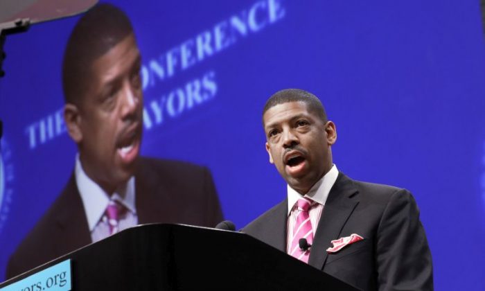 FILE -In this June 23, 2014 file photo, Sacramento, Calif., Mayor Kevin Johnson, president of the U.S. Conference of Mayors, speaks before a panel discussion about sports and race relations during a conference meeting in Dallas. A man hit Mayor Johnson in the face with a pie at a charity dinner. The mayor's Chief of Staff Crystal Strait called the Wednesday night, Sept. 21, 2016, incident at the Sacramento Charter High School a shocking assault, but said the mayor wasn't hurt. (AP Photo/LM Otero, File)