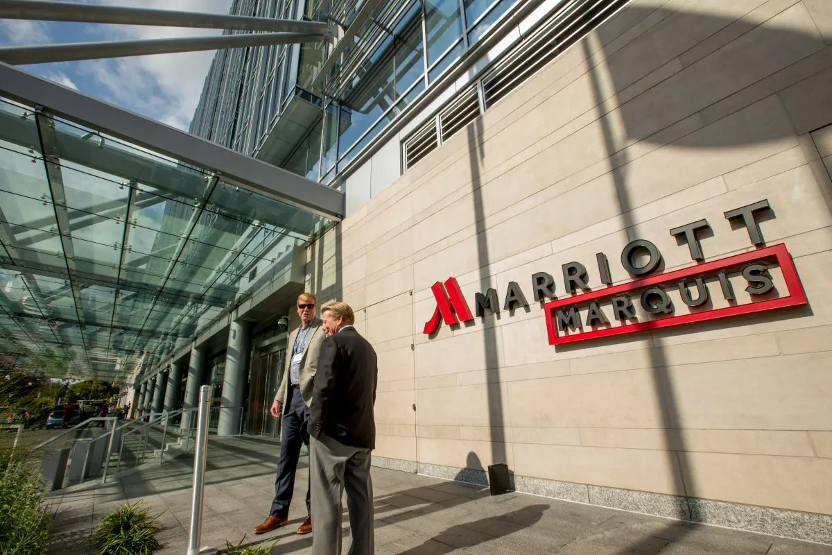 Two men stand outside the newly-built Marriott Marquis hotel in Washington on Oct. 14, 2015. (AP Photo/Andrew Harnik)