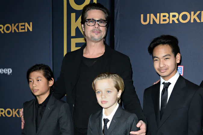 Actor Brad Pitt and children Pax Jolie-Pitt (L), Shiloh Jolie-Pitt (C) and Maddox Jolie-Pitt arrive for the U.S. premiere of Universal Pictures 'Unbroken,' December 15, 2014 at the Dolby Theatre in Hollywood, California. Brad The Los Angeles County Department of Children and Family Services has reportedly extended its investigation of child abuse allegations against Pitt. (ROBYN BECK/AFP/Getty Images)