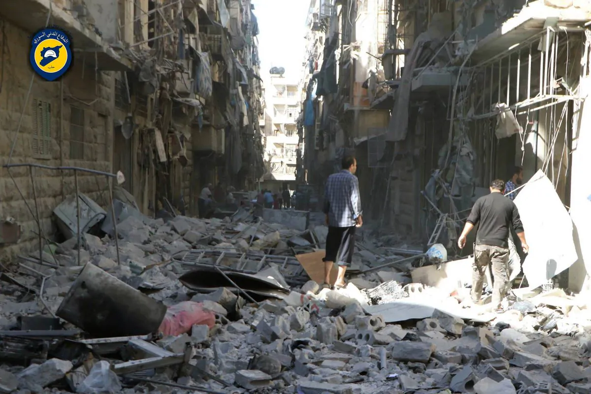 Syrians inspect damaged buildings after airstrikes hit in Aleppo, Syria, on Sept. 24, 2016. (Syrian Civil Defense White Helmets via AP)