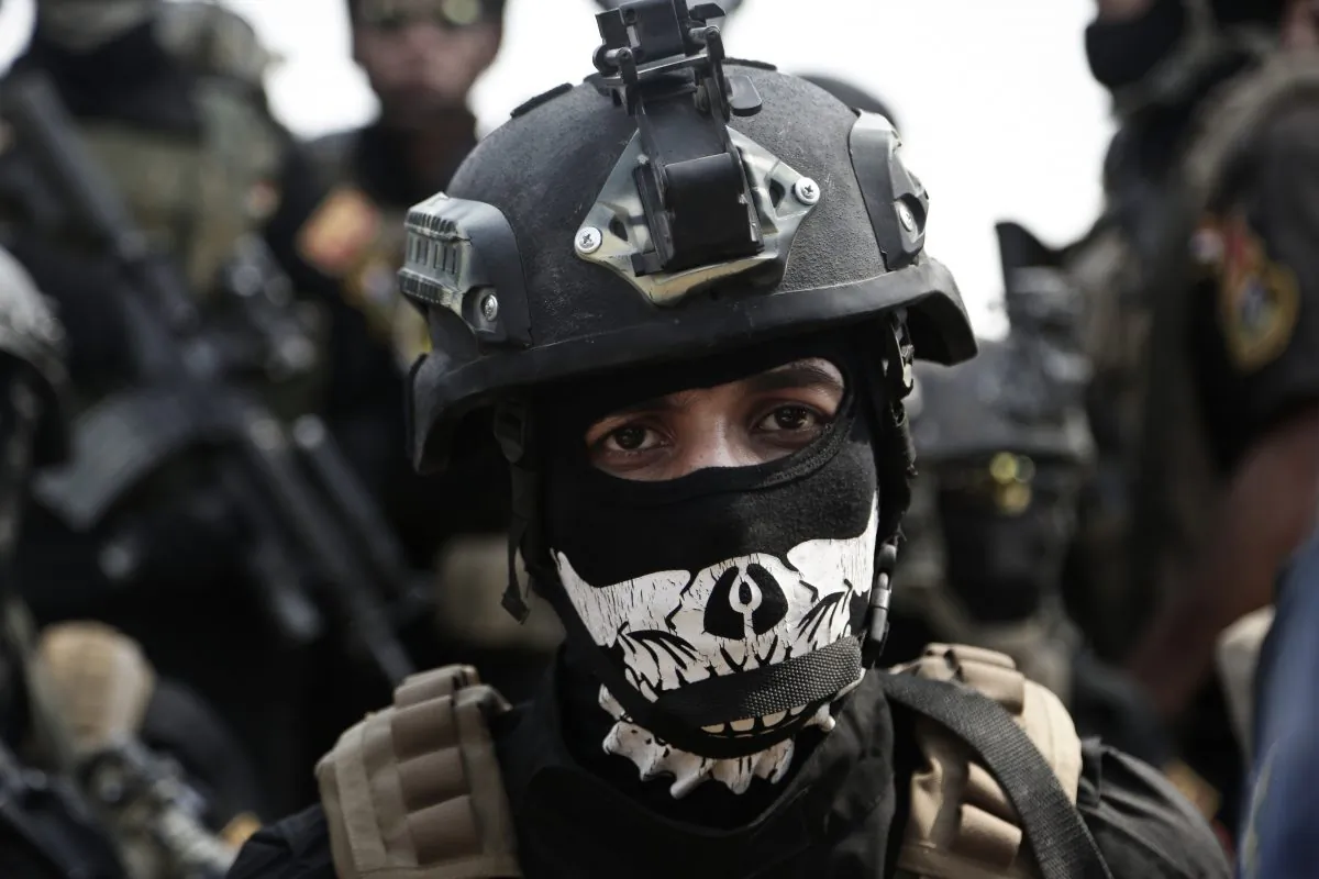 A soldier from the 1st Battalion of the Iraqi Special Operations Forces listens to an address by his commander after a training exercise to prepare for the operation to retake Mosul from Islamic State militants, in Baghdad, Iraq, on Aug. 13, 2016. (AP Photo/Maya Alleruzzo)