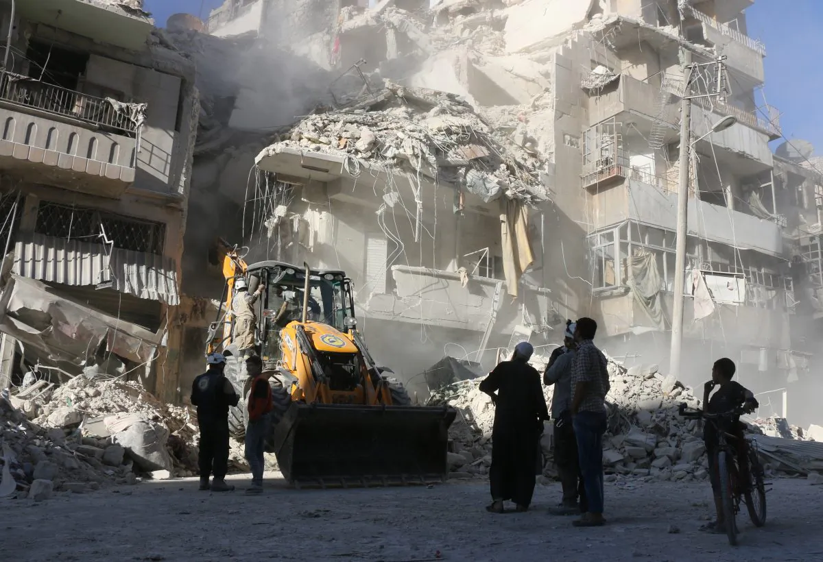 Civilians watch as a tractor clears the rubble following Syrian government forces airstrikes in the rebel held neighborhood of Tariq a-Bab in Aleppo on Sept. 24, 2016. Residents in Syria's battleground city of Aleppo cowered indoors as fierce airstrikes toppled buildings and killed at least 52 civilians, after diplomatic efforts to revive a ceasefire failed. (Thaer Mohammed/AFP/Getty Images)