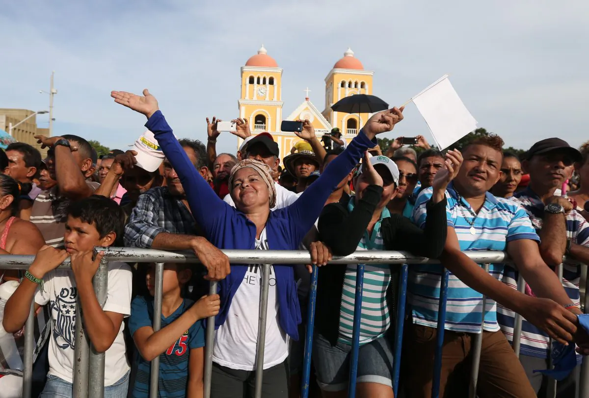 People enjoy a concert for peace in Carmen de Bolivar, Colombia, Sunday, Sept. 25, 2016. Colombia's government and the Revolutionary Armed Forces of Colombia, FARC, will sign a peace agreement to end over 50 years of conflict, in Cartagena, on Monday. (AP Photo/Fernando Vergara)