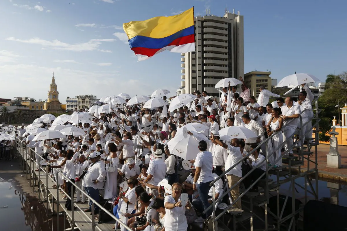 People wait for the start of the peace ceremony prior the signing of a peace agreement between Colombia’s government and the Revolutionary Armed Forces of Colombia, FARC, in Cartagena, Colombia, on Sept. 26. (AP Photo/Fernando Vergara)
