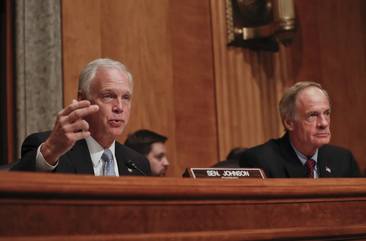 Senate Homeland Security and Governmental Affairs Committee Chairman Sen. Ron Johnson, R-Wis. (L) accompanied by the committee's ranking member Sen. Tom Carper, D-Del., at Capitol Hill in Washington on Sept. 27, 2016. (Pablo Martinez Monsivais/AP Photo)