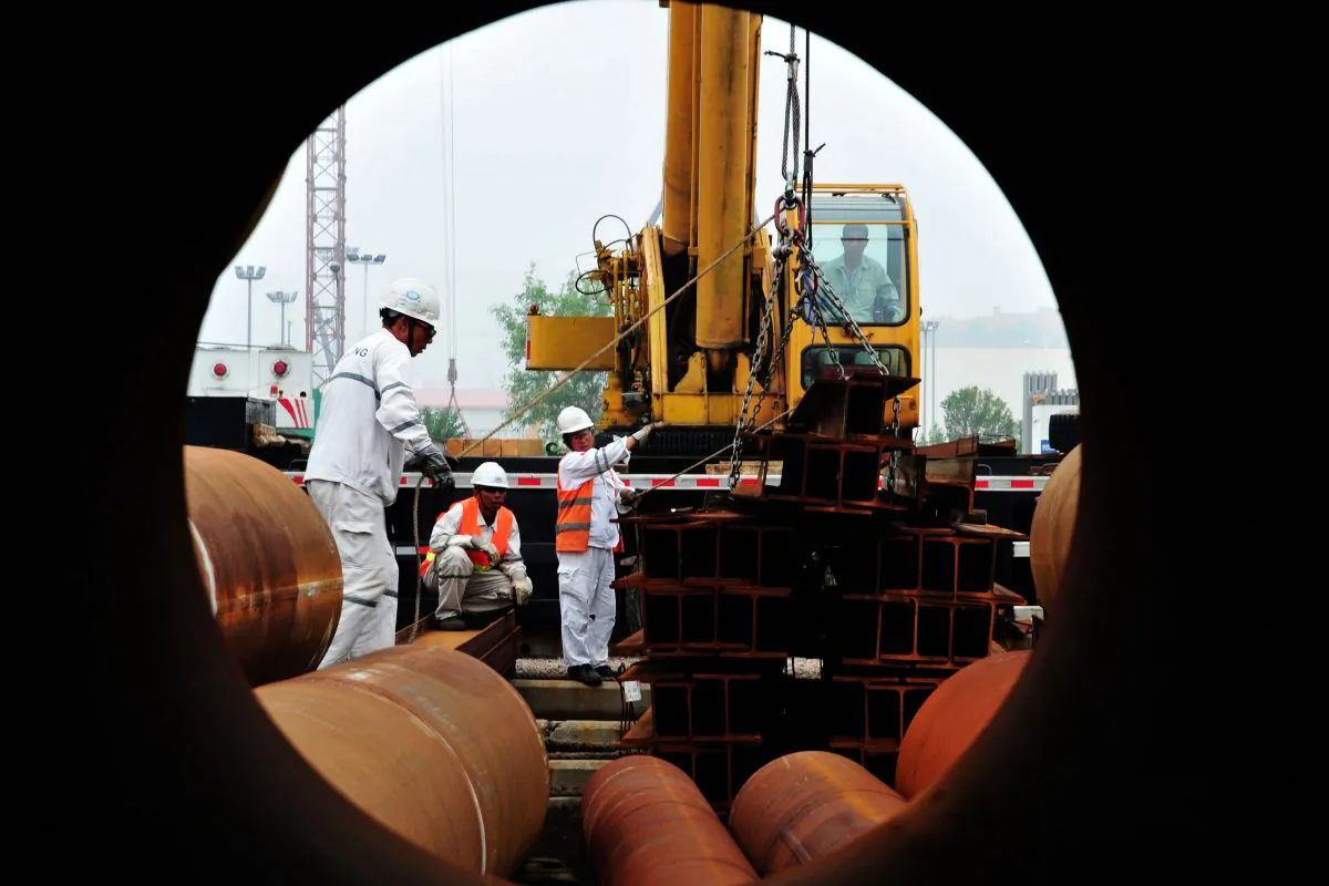 People work at an offshore oil engineering platform in Qingdao, China, July 1, 2016.  According to the independent China Beige Book survey, the economy has stabilized, but this improvement comes at a price.
(STR/AFP/Getty Images)