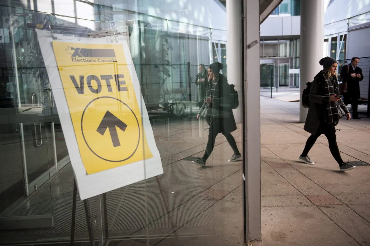 An Elections Canada sign points voters toward the polls at Metro Hall in Toronto during the federal election on Oct. 19, 2015. (THE CANADIAN PRESS/Marta Iwanek)