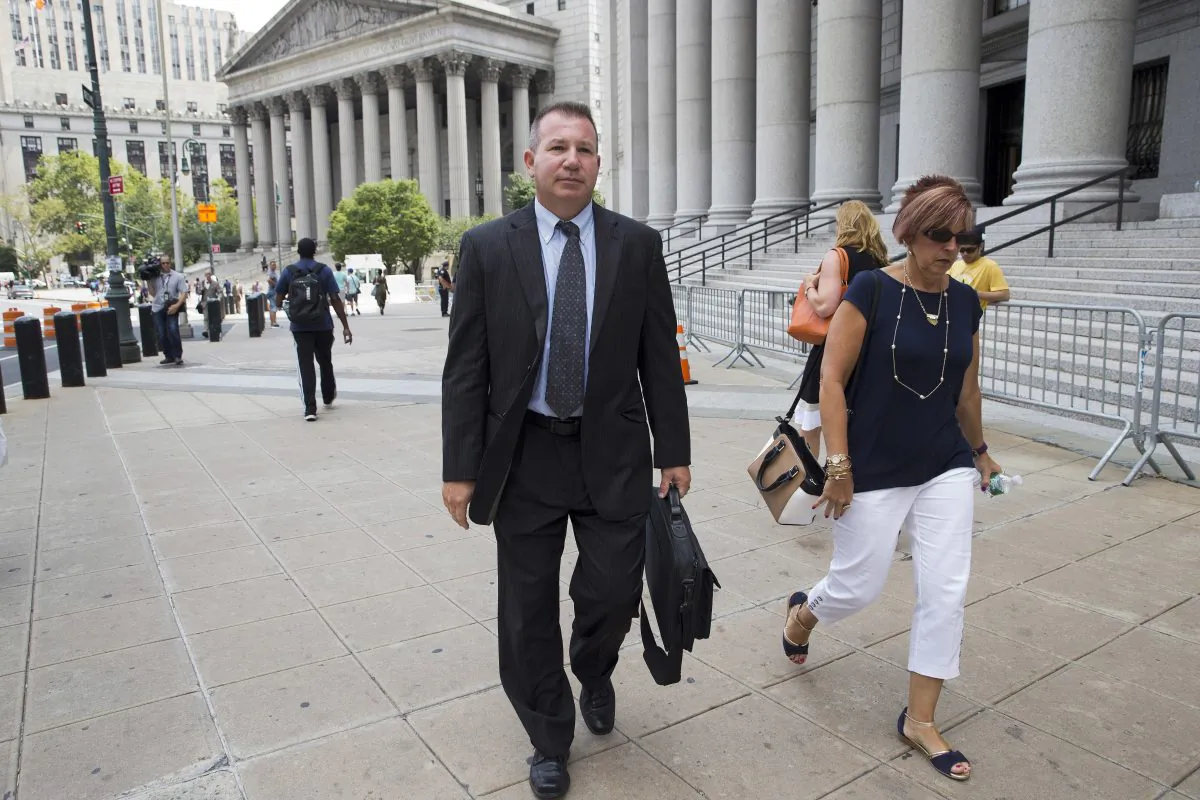 In this July 13, 2016 photo, retired New York Police Department Sgt. Ronald Buell, center, leaves federal district court in Manhattan. Buell received probation for selling National Crime and Information Center information to a private investigator for defense attorneys. At his sentencing, Buell said he hoped other officers would learn "to never put themselves in the position I'm in." (AP Photo/Mary Altaffer)