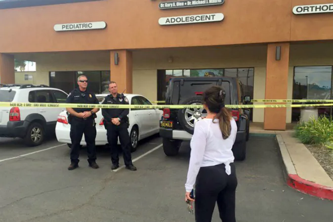 This still from video provided by 10News.com shows a woman facing police officers near where police shot and killed Alfred Olango in the San Diego suburb of El Cajon, Calif., Thursday, Sept. 27, 2016. (10News.com via AP)