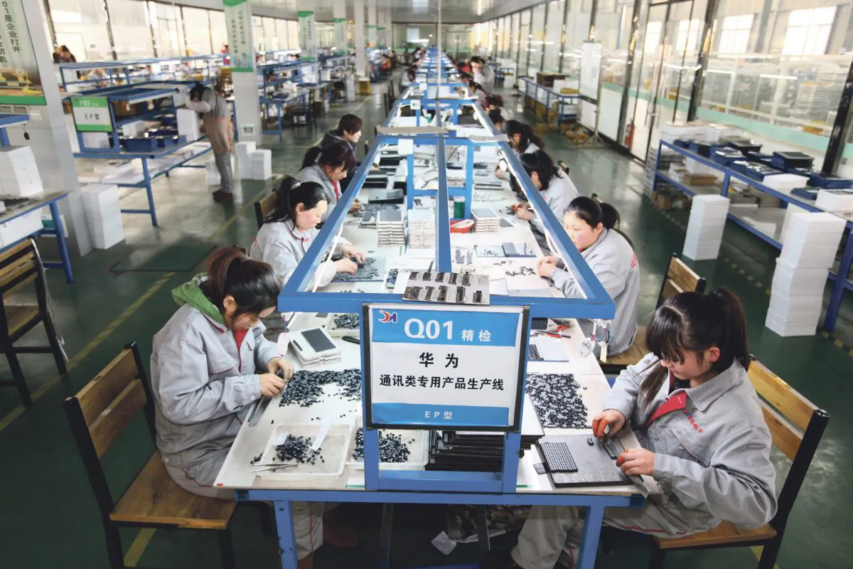 Workers sort parts at an electronics company in Tengzhou, in China’s eastern Shandong province, on Feb 1, 2016. (STR/AFP/Getty Images)