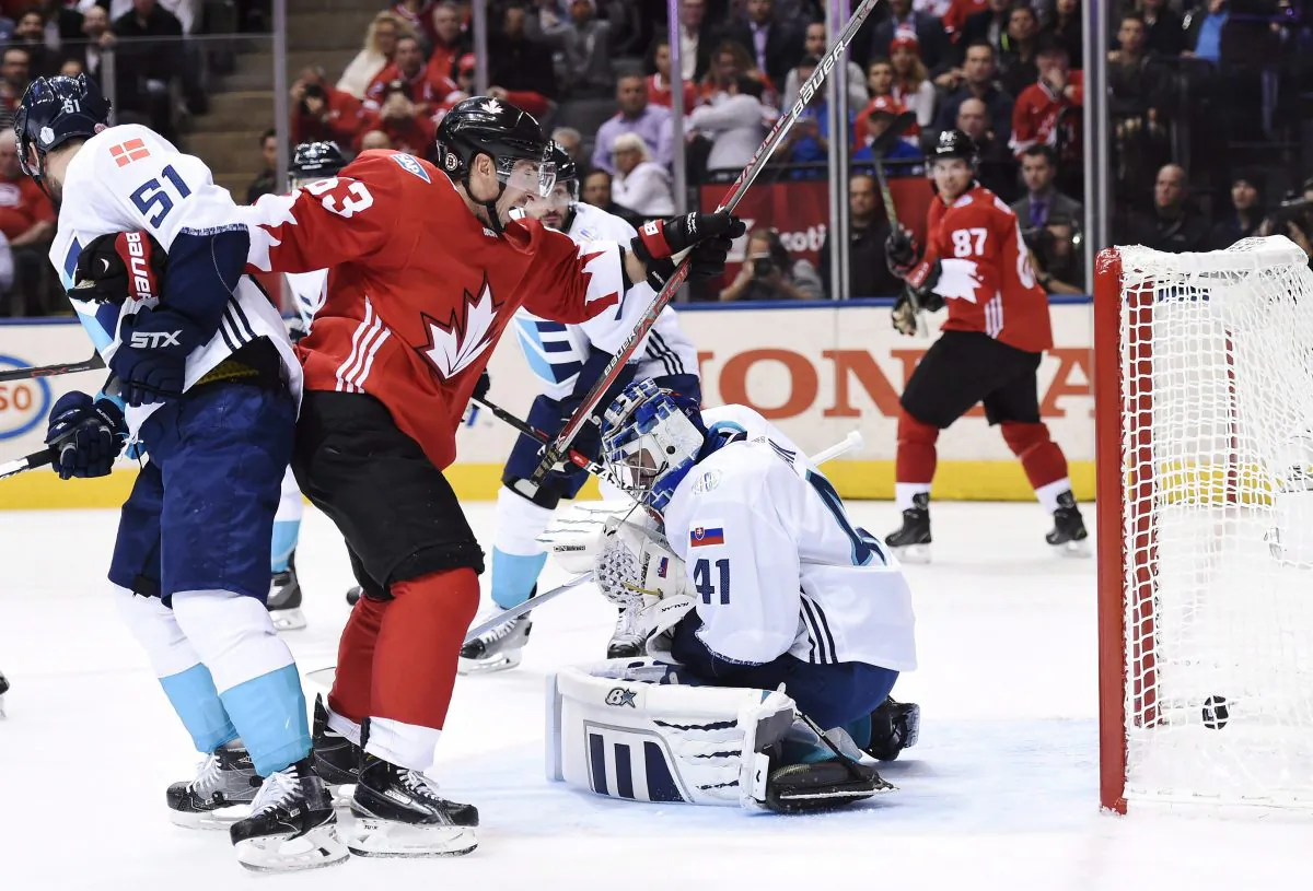 Team Canada's Brad Marchand and Sidney Crosby celebrate Patrice Bergeron’s goal while Team Europe's Frans Nielsen looks on during World Cup of Hockey finals action in Toronto on Sept. 27, 2016. (The Canadian Press/Nathan Denette)