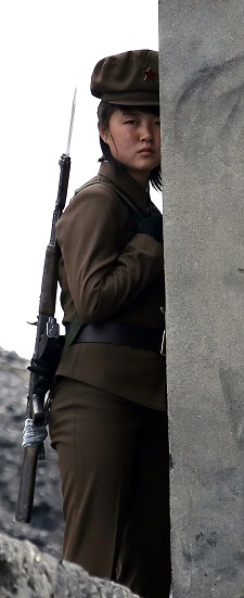 A North Korean soldier patrols the bank of the Yalu River separating the country from the Chinese border city of Dandong on April 26, 2014. (STR/AFP/Getty Images)