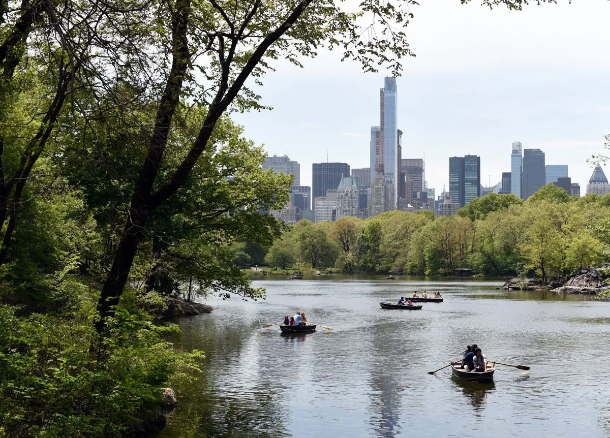 With a section of the Manhattan skyline in the background, people row around the lake in Central Park  May 12, 2014, in New York, taking advantage of the warm weather.  (TIMOTHY A. CLARY/AFP/Getty Images)