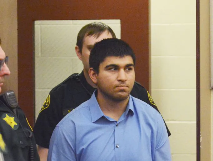 Arcan Cetin is escorted into Skagit County District Court by Skagit County's Sheriff's Deputies on Monday, Sept. 26, 2016. Cetin is being held under a magistrate's warrant which will give Skagit County prosecutors 30 days to file charges in relation to the Cascade Mall shooting that took place on Friday evening. Five people were killed in the shooting, and Cetin is being held on a $2 million bail. (Brandy Shreve/Skagit Valley Herald via AP)