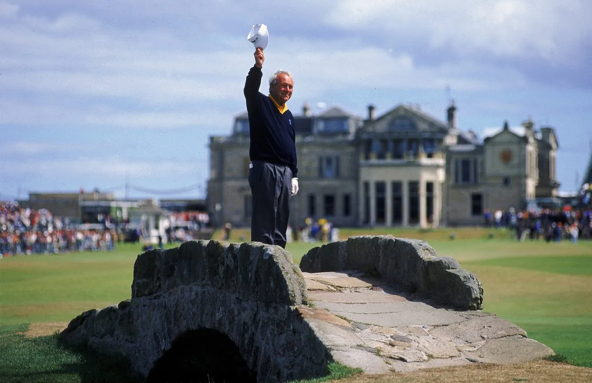 Arnold Palmer waves to the crowd from the Swilken Bridge on the 18th hole during the second round of the British Open at St Andrews in Scotland. This proved to be a farewell from Palmer as shortly after the round he announced this would be his last British Open appearance. (Stephen Munday /Allsport/Getty Images)