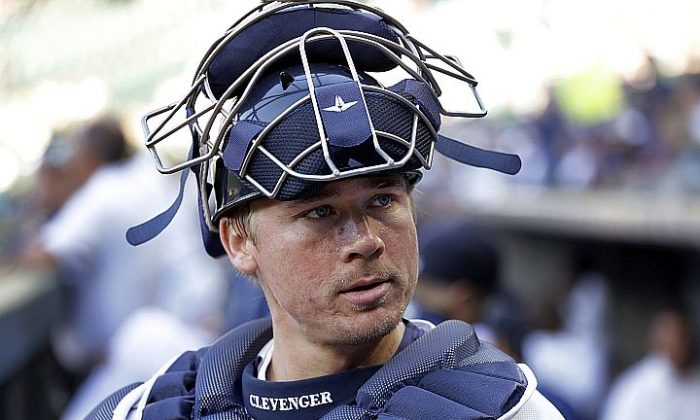 A June 29, 2016, file photo, Seattle Mariners catcher Steve Clevenger looks out of the dugout before a baseball game against the Pittsburgh Pirates in Seattle. Clevenger was suspended for the rest of the season without pay Friday, Sept. 23, 2016, by the Mariners in the wake of his tweets regarding a recent police shooting in Charlotte, N.C., and the Black Lives Matter movement.  (AP Photo/Elaine Thompson, File)