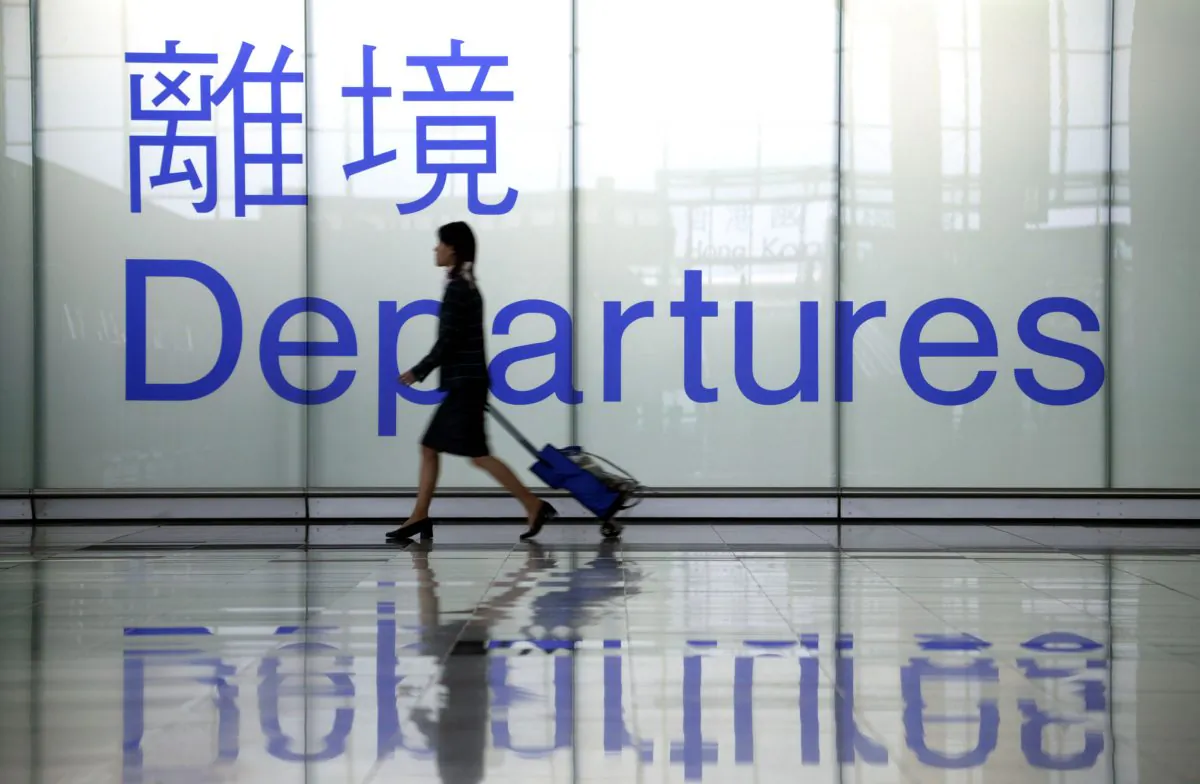 A woman heads towards a departure gate at Chek Lap Kok airport in Hong Kong in this file photo. (Christian Keenan/Getty Images)