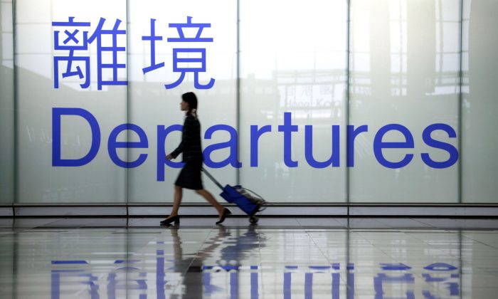 A woman heads towards a departure gate at Chek Lap Kok airport in Hong Kong in this file photo. (Christian Keenan/Getty Images)
