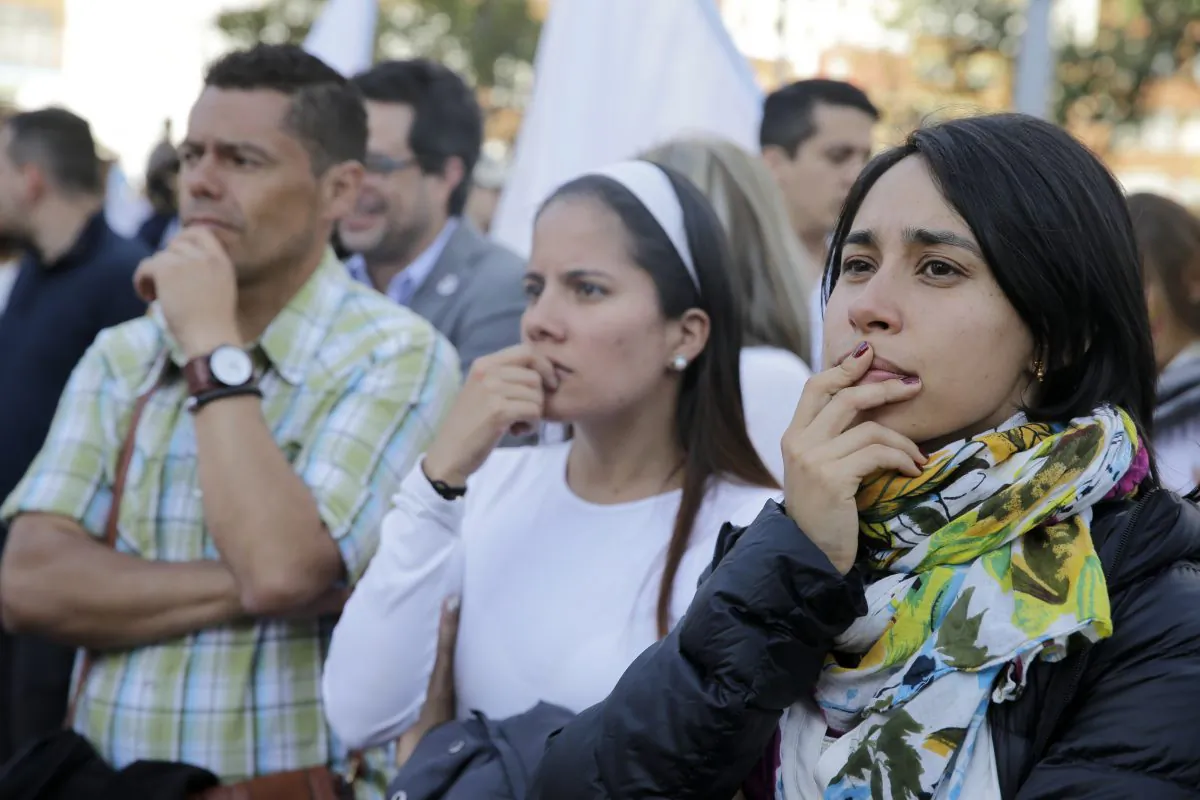 Supporters of the peace accord between the Colombian government and rebels of the Revolutionary Armed Forces of Colombia, FARC, follow on a giant screen the results of a referendum to decide whether or not to support the peace accord  in Bogota, Colombia, Sunday, Oct. 2, 2016. The peace deal is expected to end more than 5 decades of conflict between the FARC and the government. (AP Photo/Ricardo Mazalan)