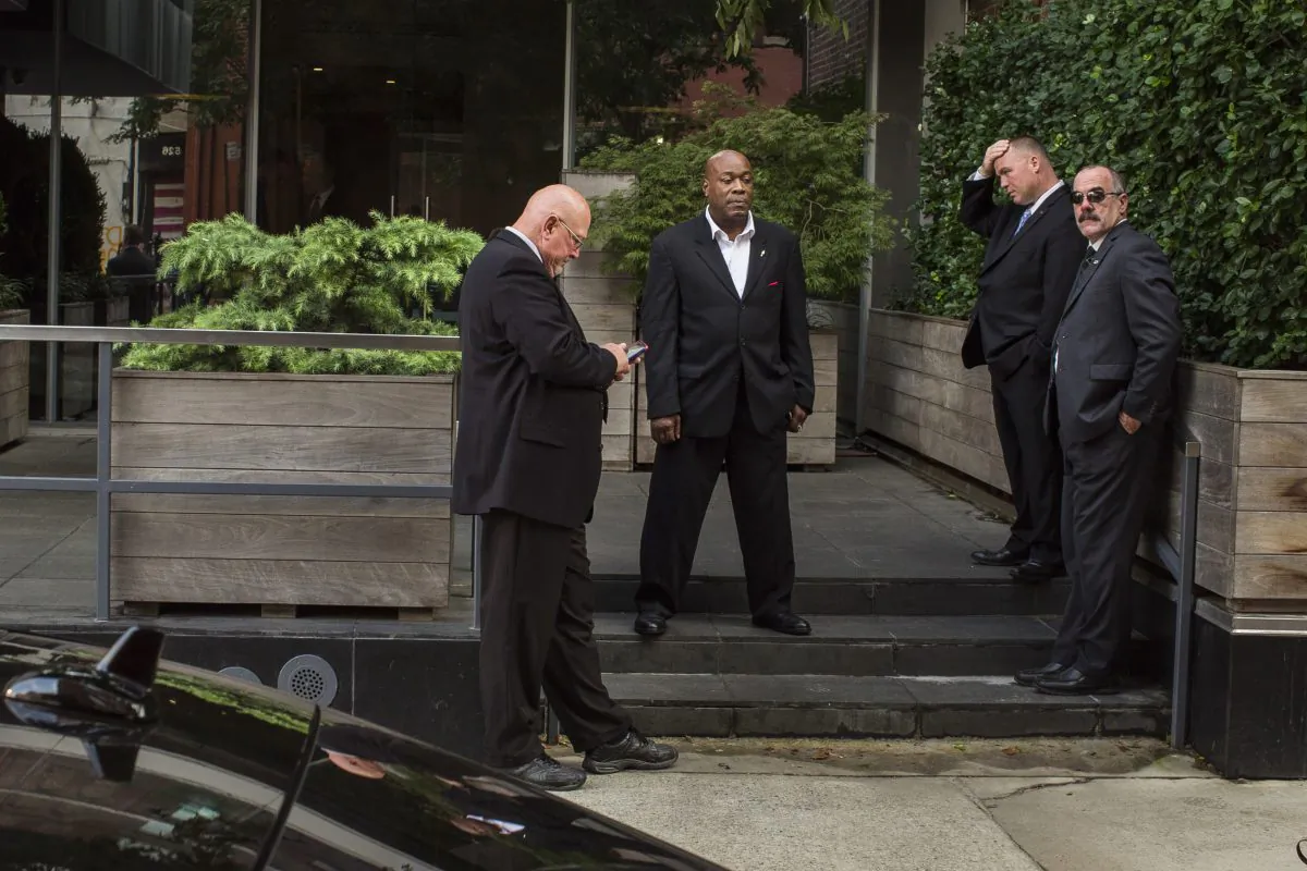 Security guards stand outside of the building where Kim Kardashian West and her husband Kanye West are staying in New York on Oct. 3, 2016. (AP Photo/Andres Kudacki)