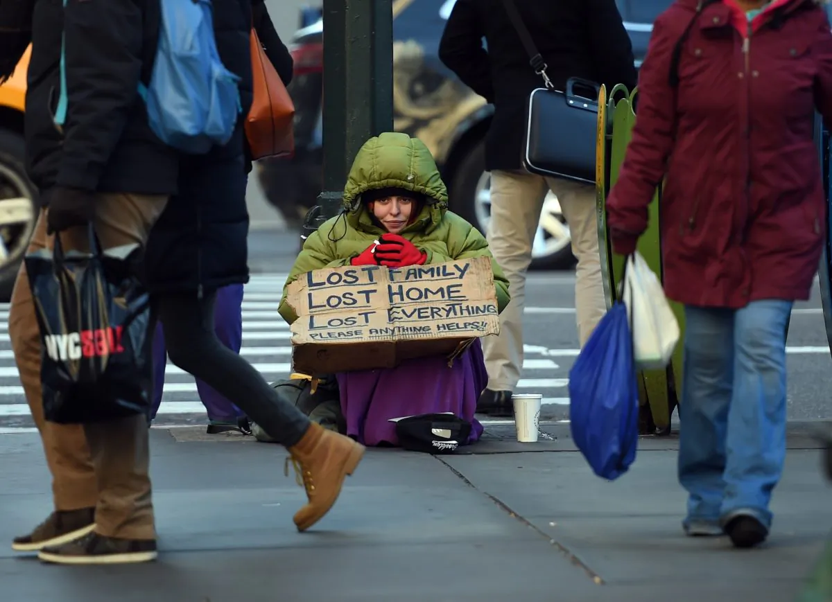 A homeless woman on 5th Avenue tries to stay warm in the cold temperatures last January in New York. (TIMOTHY A. CLARY/AFP/Getty Images)