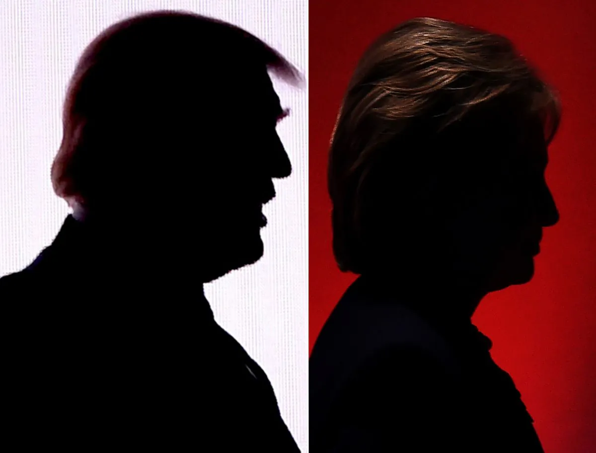 The silhouettes of Republican presidential nominee Donald Trump (L) on July 18, 2016, and Democratic presidential nominee Hillary Clinton on Feb. 4, 2016. (DESK/AFP/Getty Images)